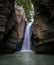 the view of the waterfall in the middle of the hill gap