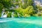 View of waterfall at Plitvice lakes, Croatia. Panoramic view of fresh nature, blue water and green trees
