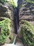 The view of the waterfall, trees, grass and river