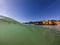 View of a wave breaking at the beautiful Alemao Beach in Portimao