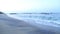 View of waves and fishermen in Mirissa. These traditional fishermen find it harder to make a living from poor fishing catches.