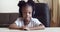 View from webcam little cute girl child african american kid wears headphones speaks into microphone communicates with
