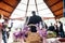 A view on the wedding couple standing in the restaurant from behind. Glasses with champagne stand on the table