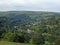 View of west yorkshire countryside with trees and fields in the calder valley with the village of luddenden