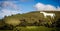 View of Westbury White Horse in Wiltshire, UK with  paragliders above