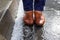 View on wet shoes standing near hailstones after hailstorm