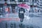 View from a wet window to a pedestrian with an umbrella on a rainy day in the streets of Bilbao