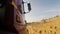 View from a wheel of the off-road truck riding in a dirt road on cloudy sky background. Scene. Close up for red cab of a