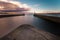 View from Whitby harbour with the piers and lighthouses. Evening sky and calm water