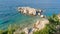 View of white rocks in the blue sea from Kassiopi shoreline, Corfu, Greece