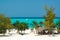 View on white sand tropical beach with palm trees and endless green ocean horizon background - Kendwa, Tanzania