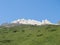 View on white shining limestone moutain peaks and rock with green grass and clear blue sky. Alpine landscape of Stubai