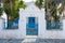 View of the white villa, and blue gate, Chora, Folegandros Island, Greece