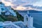 View of whitewashed buildings and Bell Tower in Oia, Greece