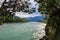 View of the wide mountain river off a cliff, overgrown with trees