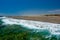 View of Wild Blue Green and Frothy Wave at the Pier at Calimera Habiba Beach Resort