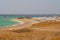 View of Wild Waves Crashing Over Coral Reef and Bedouin Tents in Wind on Beach in Marsa Alam