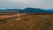 View of a wind turbine in the mountains in the background, Alternative energy, Ukrainian windmill in a field in the Carpathian