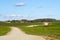 View of a winding scenic gravel road between the fields