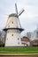 A view of a windmill at sunset on a canal just outside Middelburg, the Netherlands.