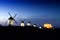 View of the windmills and castle of Consuegra in La Mancha in central Spain at night