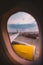 The view from the window of the airplane porthole at dawn at the airport of Barcelona. Theme of romance on a journey. Tourism and