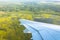 View from window of airplane to forests, fields, lakes, swamps