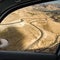 View through the window of a car onto a winding road in the desert landscape of Central Jordan not far from Wadi Mujib Reservoir