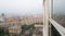 View from the window of a high-rise building on the city. A house under construction and small cars. Panoramic Windows