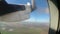 The view from the window of a light airplane on an engine with rotating propeller blades