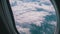 View from the window of the plane at the clouds. Airplane flies above the weather