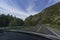 view from the window of the road, blue sky and mountains while driving while traveling in Altai