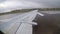 View from the Window on the Wing of an Airplane moving along the Runway at Airport