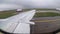 View from the Window on the Wing of an Airplane moving along the Runway at Airport