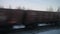 View from the window in winter on an oncoming passing freight train on the railway