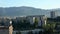 The view from the windows of a multistory building in the sleeping area of Tbilisi against the backdrop of verdant mountains.