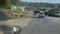 View through a windshield from inside a car. Van is going through a country road near African village, bus is passing by