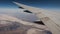 View Wing And Desert With Rock Formations From Window Of Plane Flying Altitude