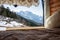 View of a winter alpine mountain through the window of a campervan