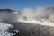 View of the winter Altai with the Biya river, fog over the river, Artybash village and mountains on the horizon. Altai Republic