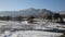 View of winter Katun with evaporation of water and mountains in the distance