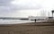 View of the winter sea. Wet sand, empty beach, cold sea, gray rain clouds. Sadness Depression.