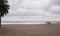 View of the winter sea. Wet sand, empty beach, cold sea, gray rain clouds. Sadness Depression.