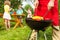 View of woman in apron fragment grilling corn