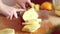 View of woman hands cutting pineapple into slices