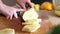 View of woman hands cutting pineapple into slices