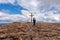 view of woman with hiking backpack reaching summit cross of mountain peak Gertrusk, Saualpe, Lavanttal Alps, Carinthia, Austria