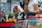 View of woman holding baguette and glass bottle with milk near supermarket counter