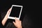 View of woman holding digital tablet with blank screen on black velvet cloth