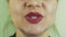 View of woman with red pomade on lips sing in front camera. Mouth. Expression.